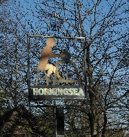 The Horningsea Village sign with a picture of a potter at the wheel
