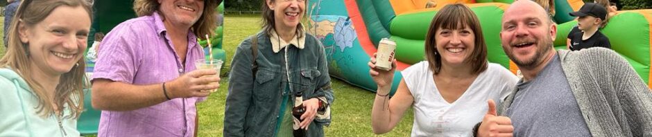 Four people smiling in front of a bouncy castle