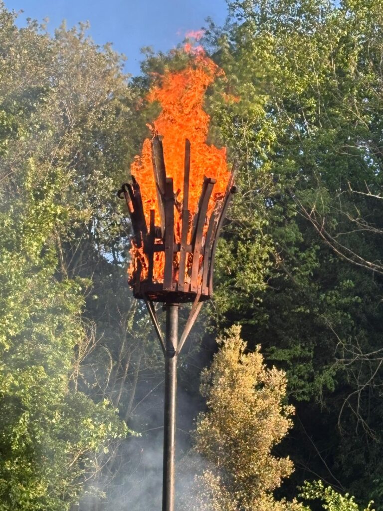 A large metal basket full of wood alight wood!
